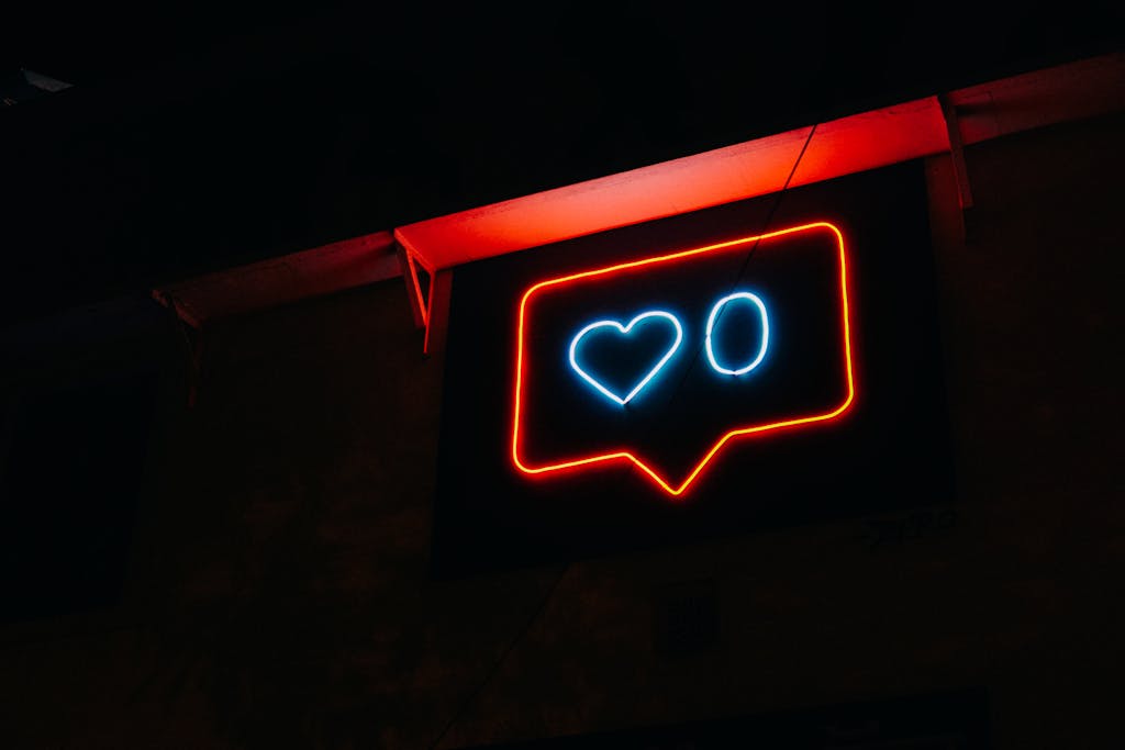 Bright neon heart icon with zero likes, symbolizing social media engagement.